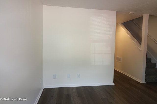 spare room featuring dark hardwood / wood-style flooring