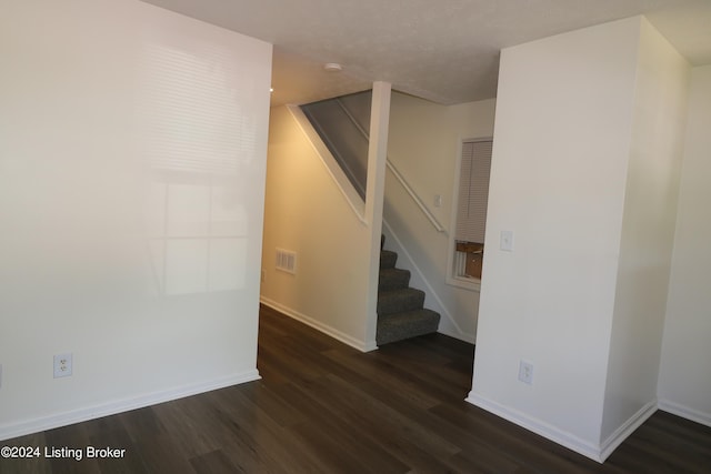 staircase with hardwood / wood-style floors