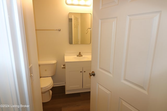 bathroom featuring hardwood / wood-style floors, vanity, and toilet