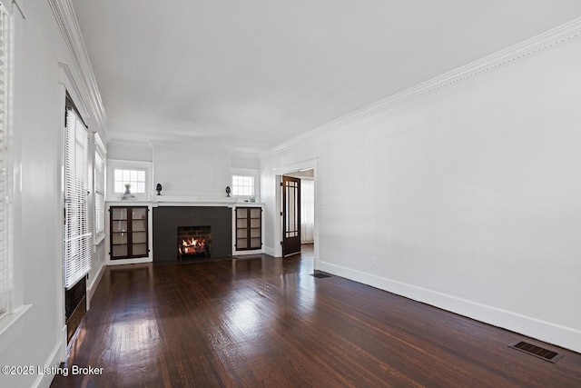 unfurnished living room featuring ornamental molding, dark hardwood / wood-style floors, and a fireplace