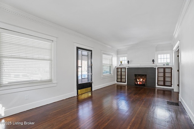 unfurnished living room featuring crown molding, dark hardwood / wood-style floors, and a brick fireplace