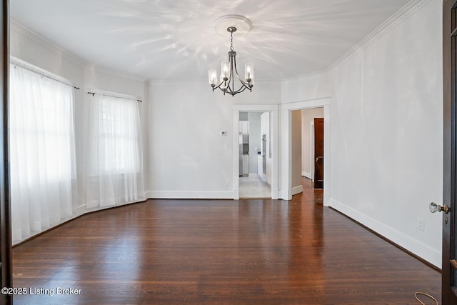 spare room with ornamental molding, dark wood-type flooring, and an inviting chandelier