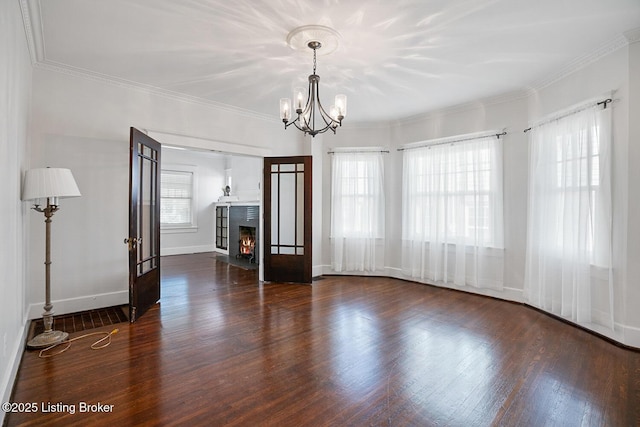 spare room with ornamental molding, dark hardwood / wood-style floors, and a healthy amount of sunlight