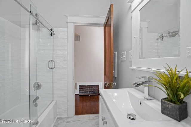 bathroom featuring vanity and combined bath / shower with glass door