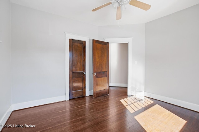 spare room with dark hardwood / wood-style floors and ceiling fan