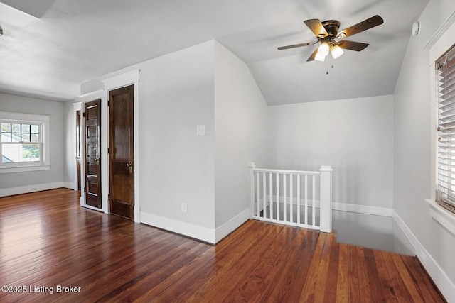 additional living space featuring ceiling fan, dark hardwood / wood-style floors, and vaulted ceiling