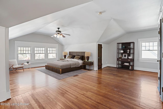 bedroom with hardwood / wood-style flooring, ceiling fan, and vaulted ceiling