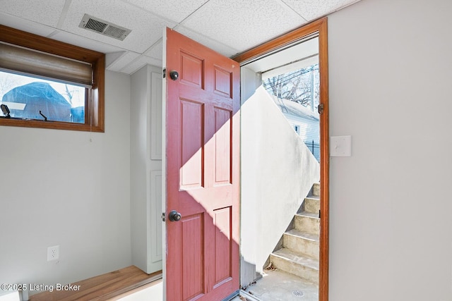 staircase with a paneled ceiling