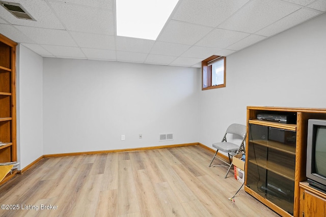 unfurnished room featuring a paneled ceiling and light hardwood / wood-style floors