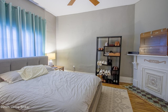 bedroom with light hardwood / wood-style floors and ceiling fan