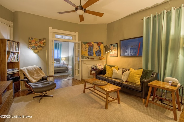 living room with ceiling fan, wood-type flooring, and french doors