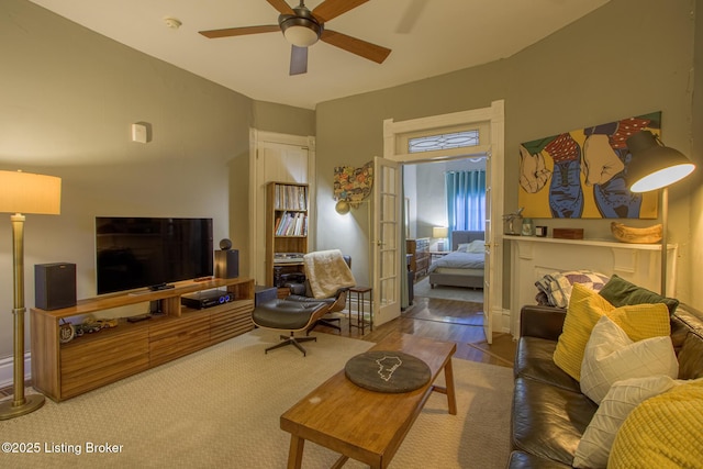 living room featuring french doors, ceiling fan, and hardwood / wood-style flooring