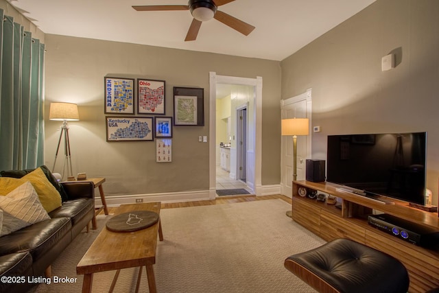 living room with ceiling fan and light hardwood / wood-style flooring