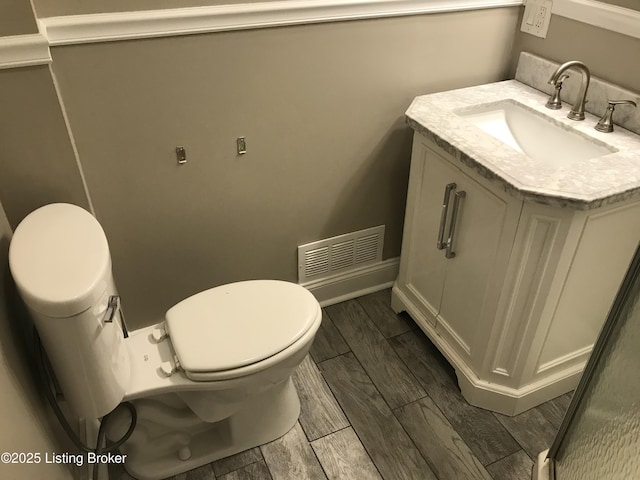 bathroom featuring toilet and vanity