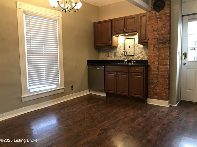 kitchen with decorative backsplash, dark hardwood / wood-style floors, a chandelier, stainless steel dishwasher, and sink