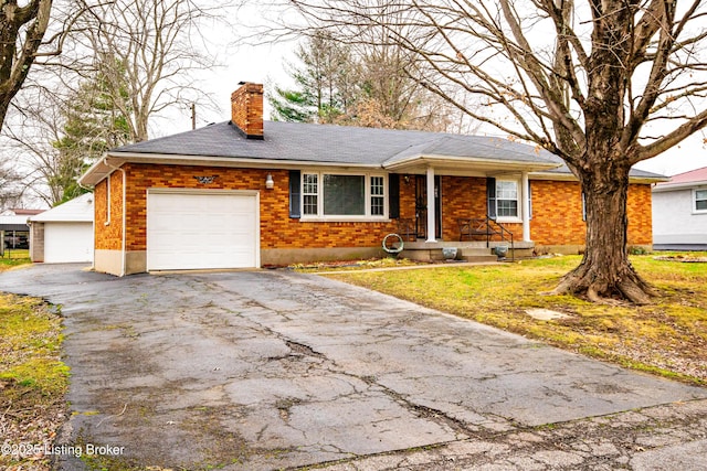 ranch-style house with a garage and a front yard