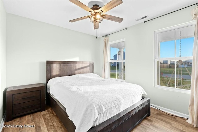 bedroom with ceiling fan and light hardwood / wood-style floors