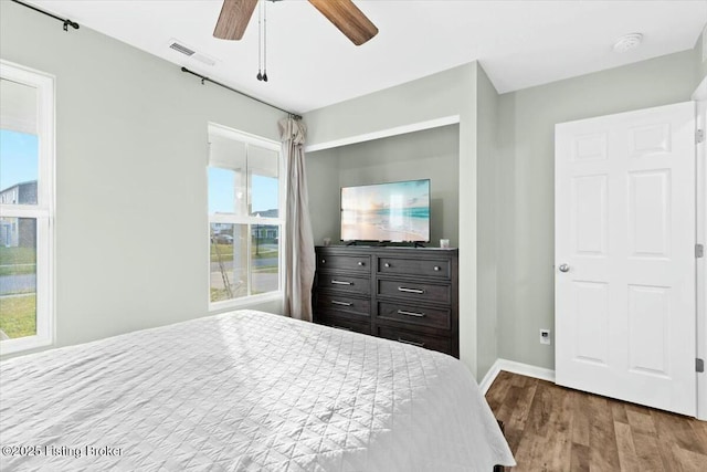 bedroom with ceiling fan and wood-type flooring