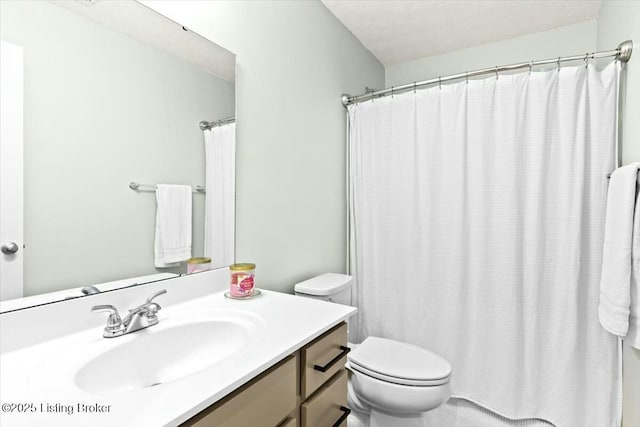 bathroom with vanity, a textured ceiling, and toilet