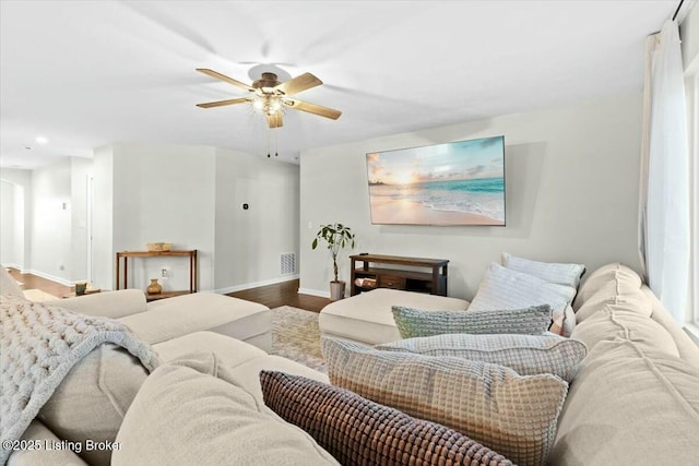 living room featuring ceiling fan and hardwood / wood-style flooring