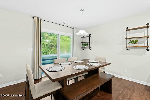 dining space featuring dark hardwood / wood-style floors