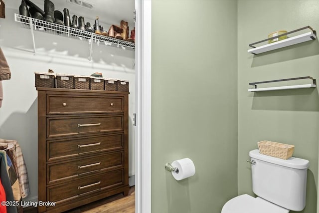 bathroom featuring hardwood / wood-style flooring and toilet