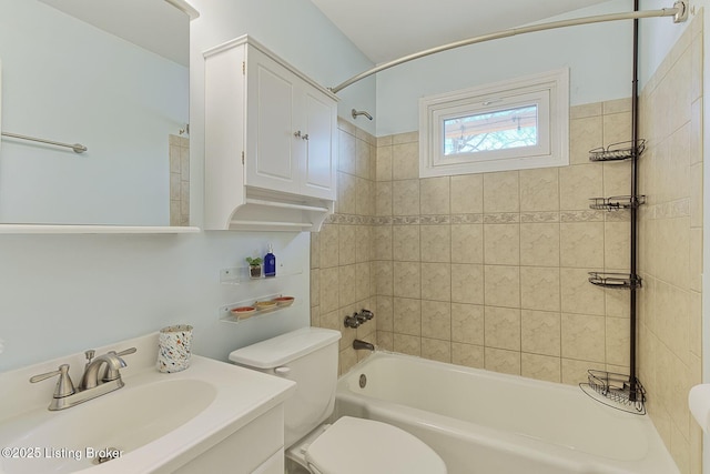 full bathroom with vanity, toilet, and tiled shower / bath combo