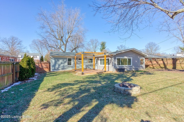 back of property featuring an outdoor fire pit, a yard, and a pergola