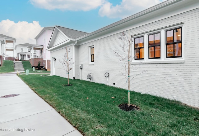 view of side of property with a yard