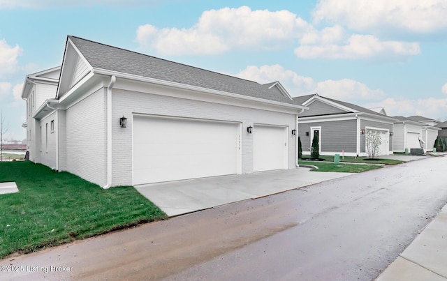 ranch-style house featuring a garage and a front lawn