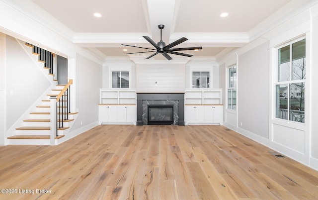 unfurnished living room featuring beamed ceiling, ceiling fan, crown molding, and light hardwood / wood-style flooring