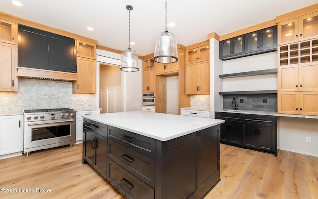 kitchen with pendant lighting, decorative backsplash, a kitchen island, and stainless steel appliances