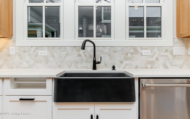 kitchen with tasteful backsplash, dishwasher, and sink