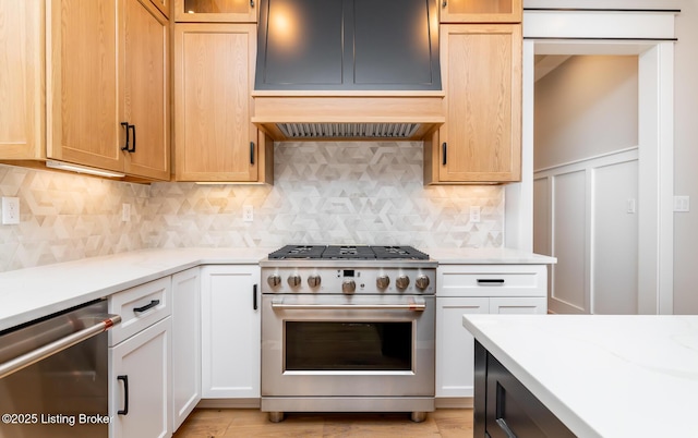 kitchen with stainless steel appliances, white cabinetry, and tasteful backsplash