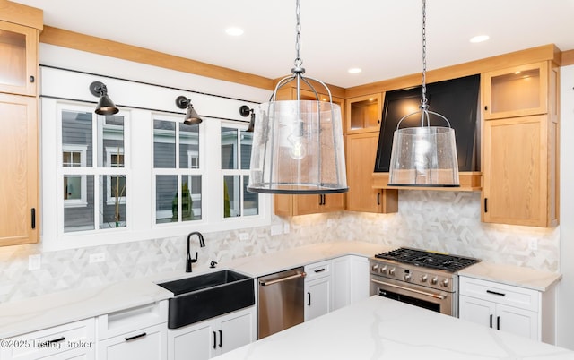 kitchen with white cabinets, stainless steel appliances, hanging light fixtures, and sink