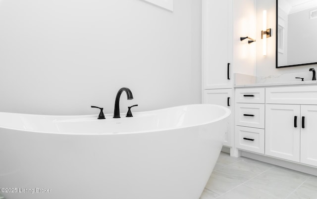 bathroom with a tub to relax in and vanity