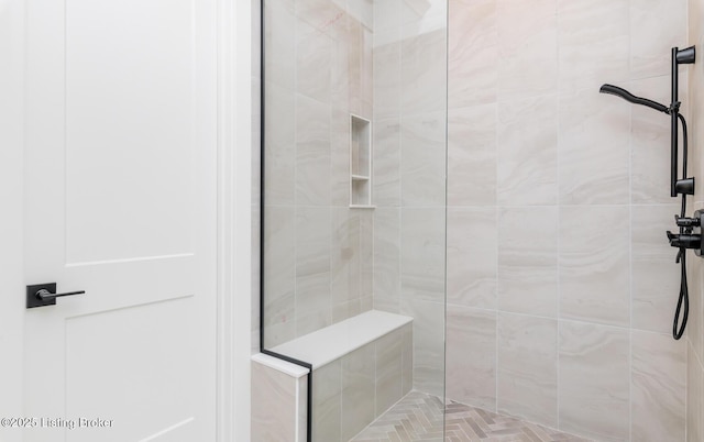 bathroom featuring a tile shower