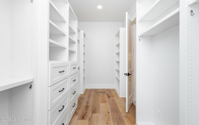 spacious closet featuring light hardwood / wood-style flooring