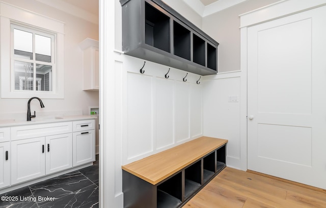 mudroom featuring crown molding and sink