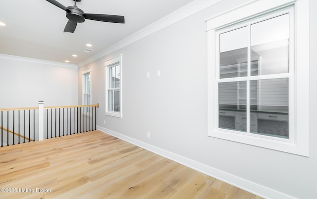 spare room featuring wood-type flooring, ceiling fan, and ornamental molding