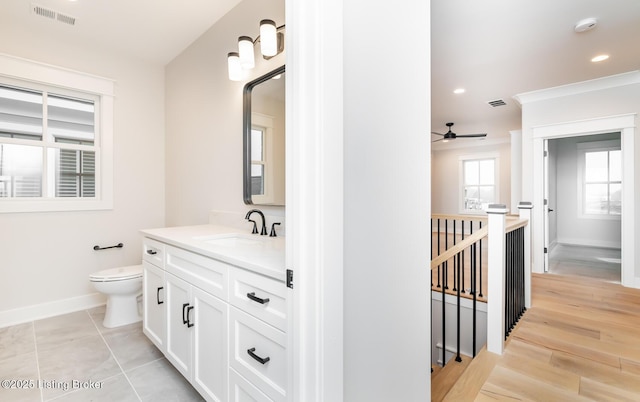 bathroom with ceiling fan, vanity, and toilet