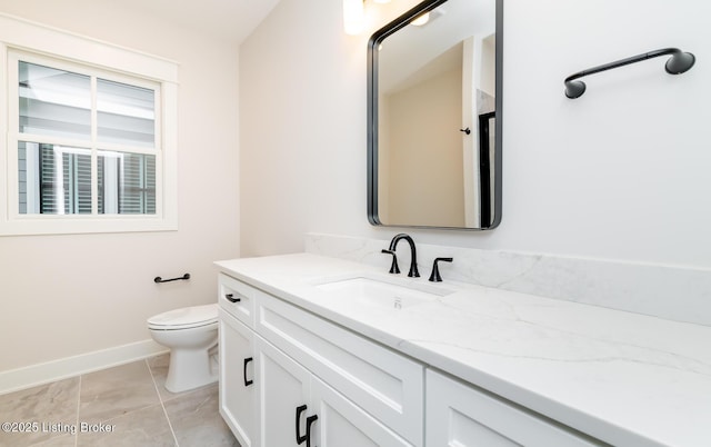 bathroom featuring tile patterned floors, vanity, and toilet