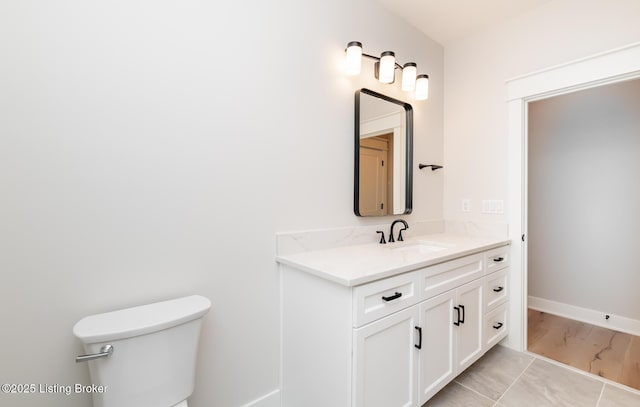 bathroom featuring tile patterned floors, vanity, and toilet