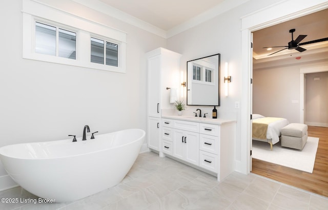 bathroom featuring a washtub, ceiling fan, crown molding, and vanity