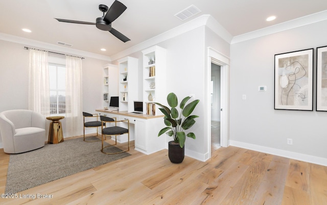 office space featuring ceiling fan, light hardwood / wood-style floors, ornamental molding, and built in features