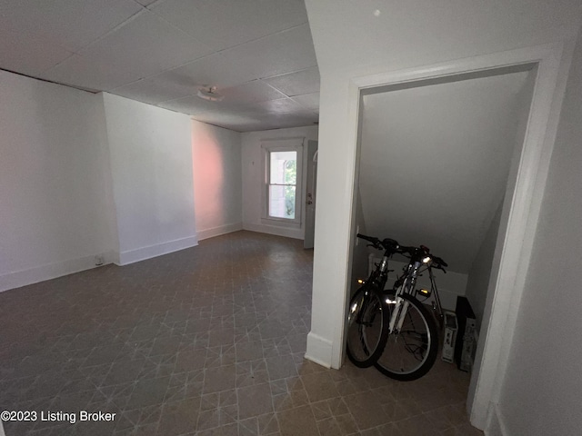 interior space with a paneled ceiling