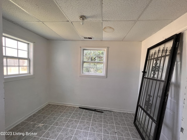 unfurnished room with a paneled ceiling