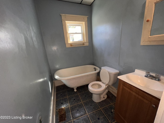 bathroom with vanity, a bathtub, and toilet