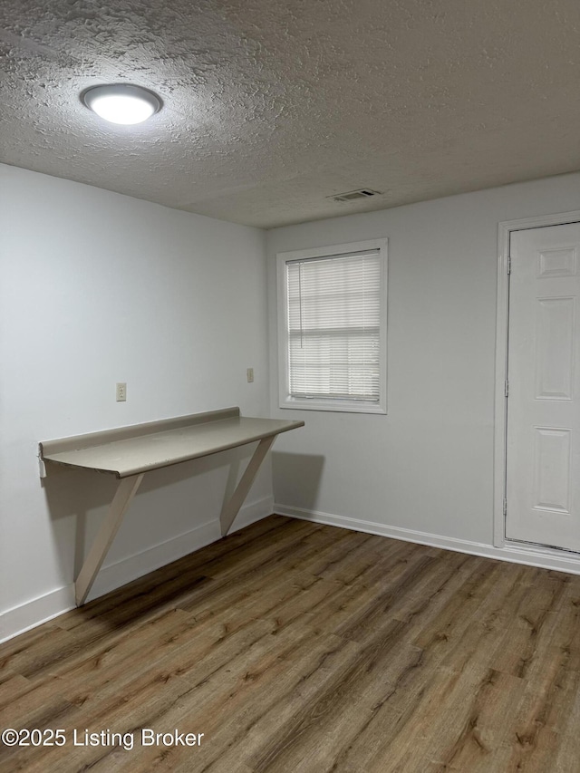 interior space featuring hardwood / wood-style floors and a textured ceiling