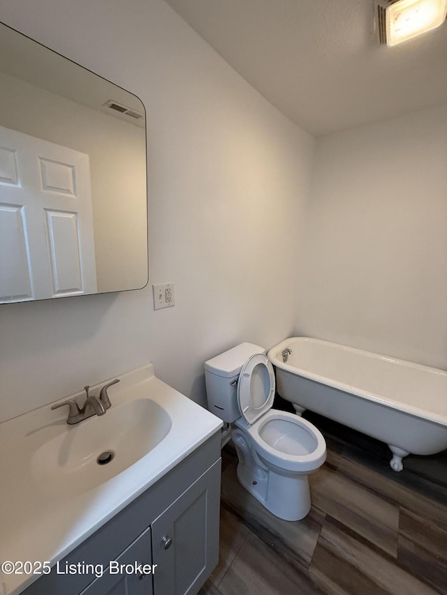 bathroom with vanity, toilet, and a bathtub